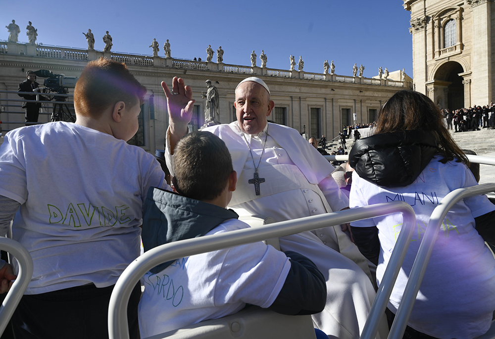 Pope Francis greets the crowd in St. Peter's Square at the Vatican while riding in the popemobile with a group of children before his general audience March 15, 2023. Pope Francis, formerly Argentine Cardinal Jorge Mario Bergoglio, died April 21, 2025, at age 88. (CNS/Vatican Media)