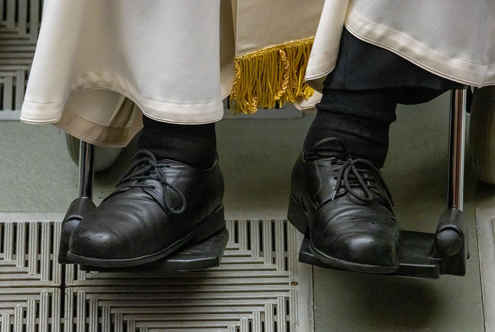 Pope Francis' shoes are seen in a photo as he greets visitors during his weekly general audience in the Paul VI Audience Hall at the Vatican May 1, 2024. (CNS/Pablo Esparza)