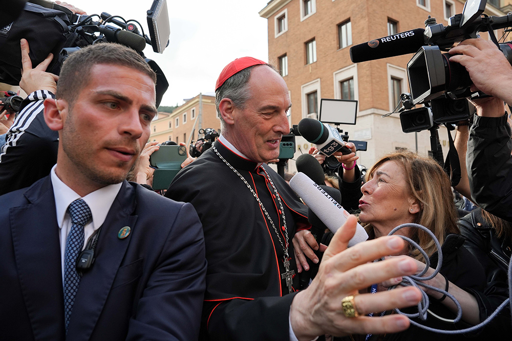 Cardinal François-Xavier Bustillo of Ajaccio, France, is surrounded by members of the media as he approaches the Petriano entrance next to St. Peter’s Square to attend a general congregation meeting in the New Synod Hall at the Vatican April 25, 2025. (CNS/Lola Gomez)
