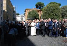 Pope Francis stands outside of Casa Santa Marta with attendees of a Pontifical Academy of Sciences meeting on the environment and climate change, in May 2014. Dan Misleh's head appears above the woman in the blue blazer to the right of Francis. (Courtesy of Dan Misleh)