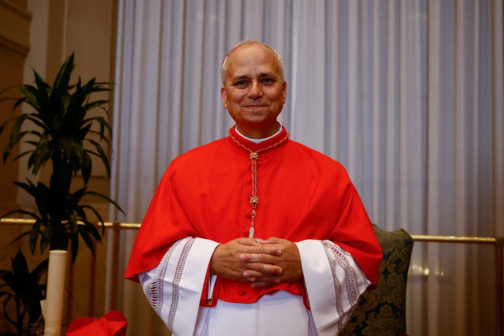Cardinal Robert Prevost, Prefect of the Dicastery for Bishops, Sept. 30, 2024. Prevost in red choir dress poses with folded hands.
